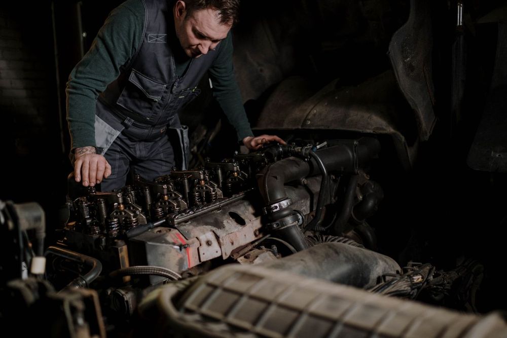 Mechanic performing diesel engine diagnostics