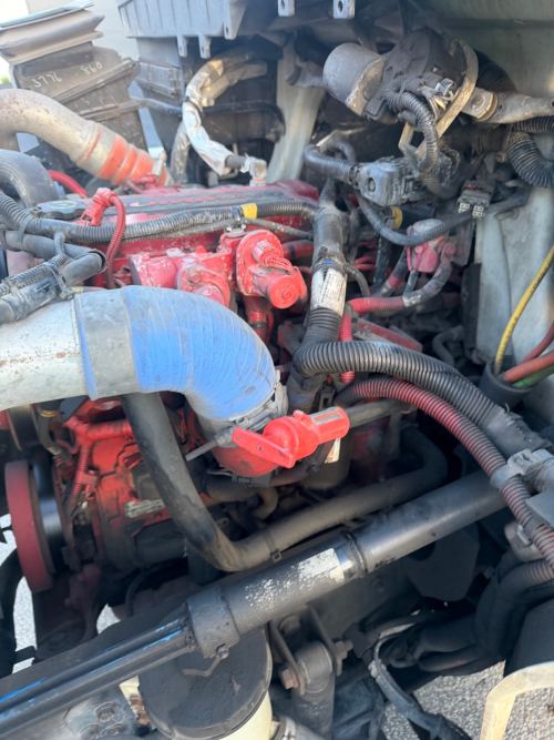 Red Cummins diesel engine bay in the shop during diagnostics work