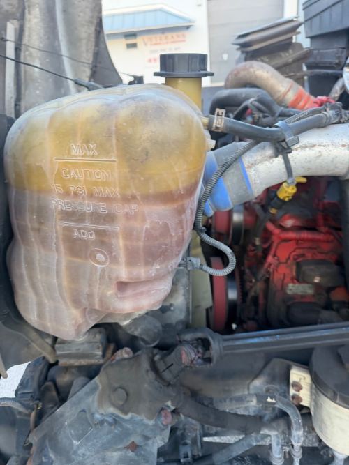 Coolant reservoir close-up on a truck during preventive maintenance inspection